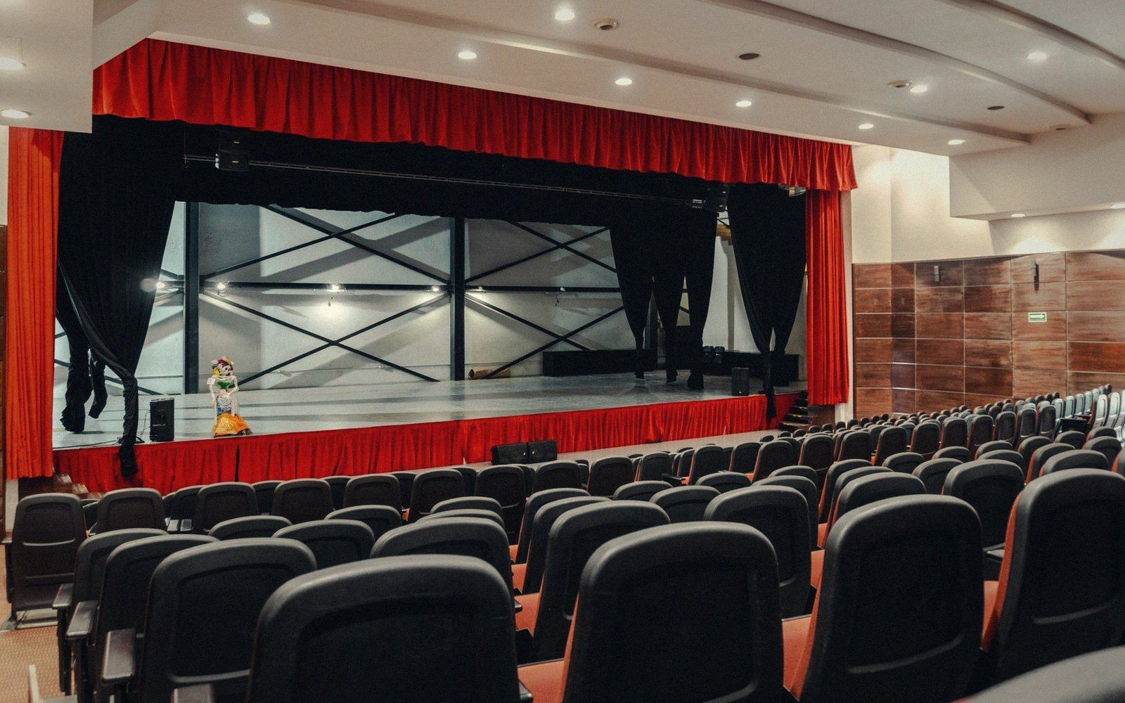 An empty auditorium with the curtain half open
